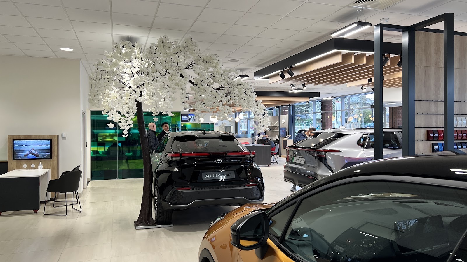 A car raised on the ramp inside the Hills of Woodford Toyota workshop bay
